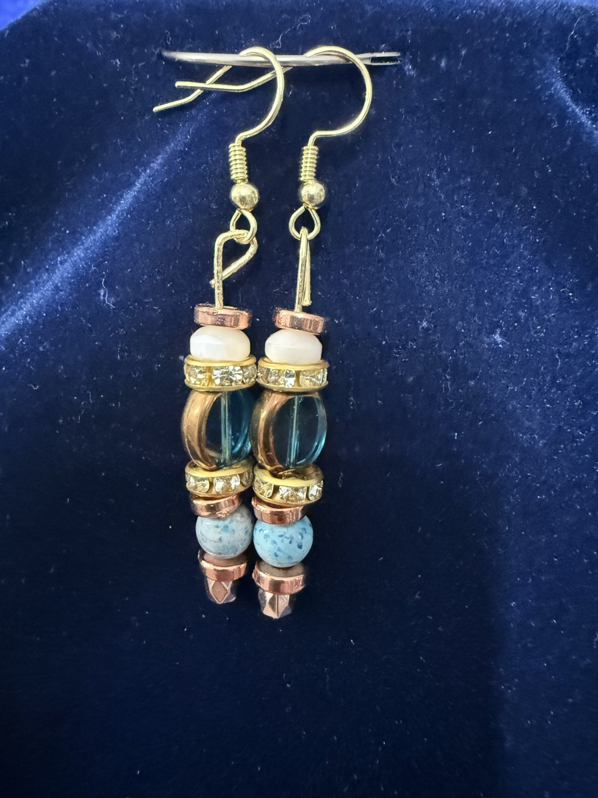 Matching earrings detail — stacked beads with gold hook