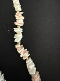 Close-up of pink and white shell chip necklace with gold spacer beads