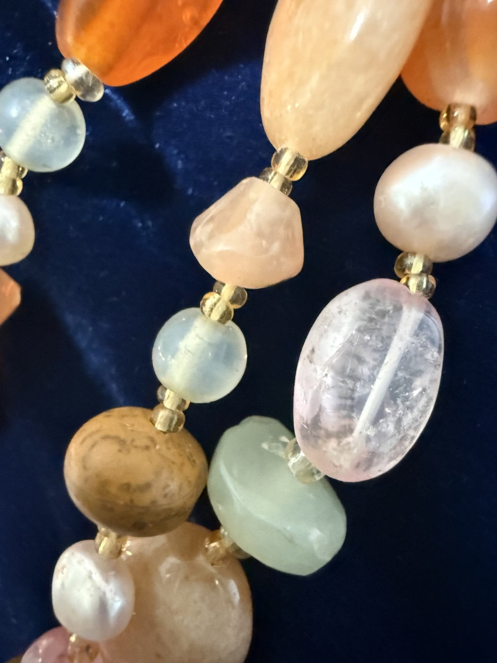 Macro detail — carnelian, burlwood, aquamarine, rose quartz and pink freshwater pearl beads