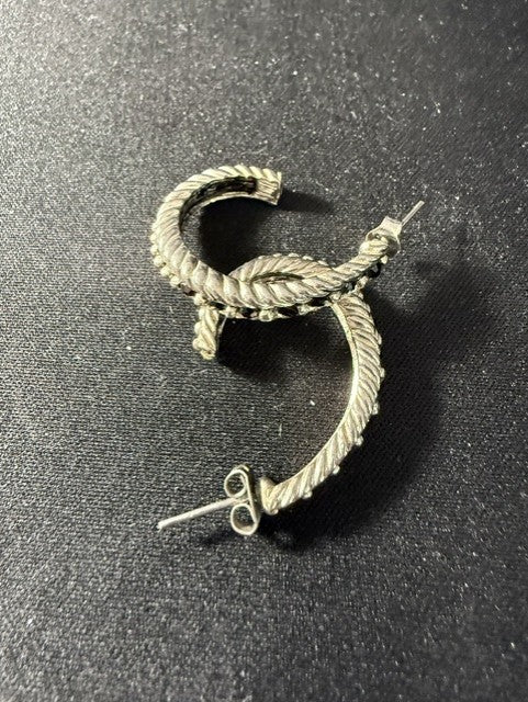 Silver-tone twisted rope hoop earrings with black gemstone channel setting