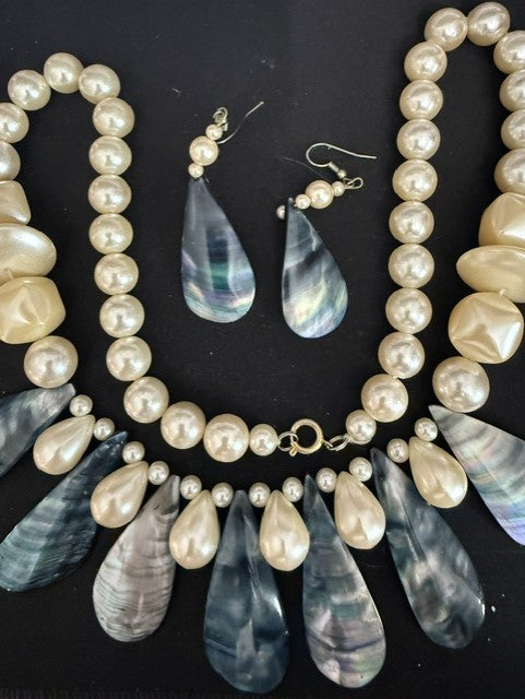 Full view of baroque pearl and iridescent shell drop necklace set with earrings