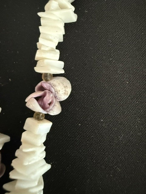 Close-up of mauve rose bud and yellow glass spacer beads