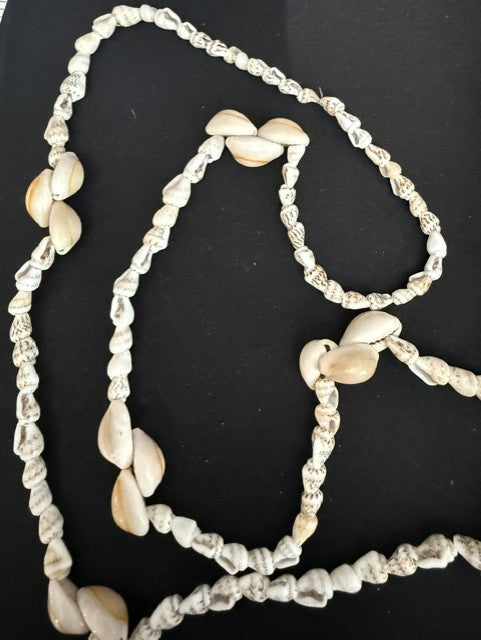 Full view of 30 inch turritella and cowrie shell continuous loop necklace