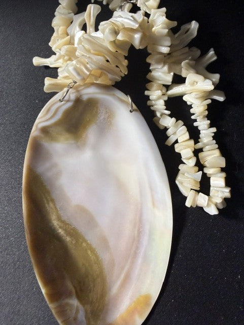 Close-up of 5-inch iridescent shell pendant showing natural color variation