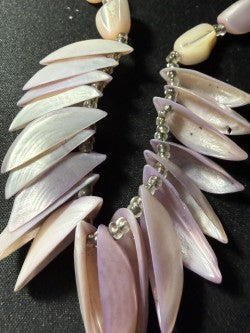 Close-up of cupped shell petal drops showing natural ridge and iridescence