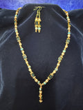 Full set — Y-drop necklace and matching earrings on navy velvet