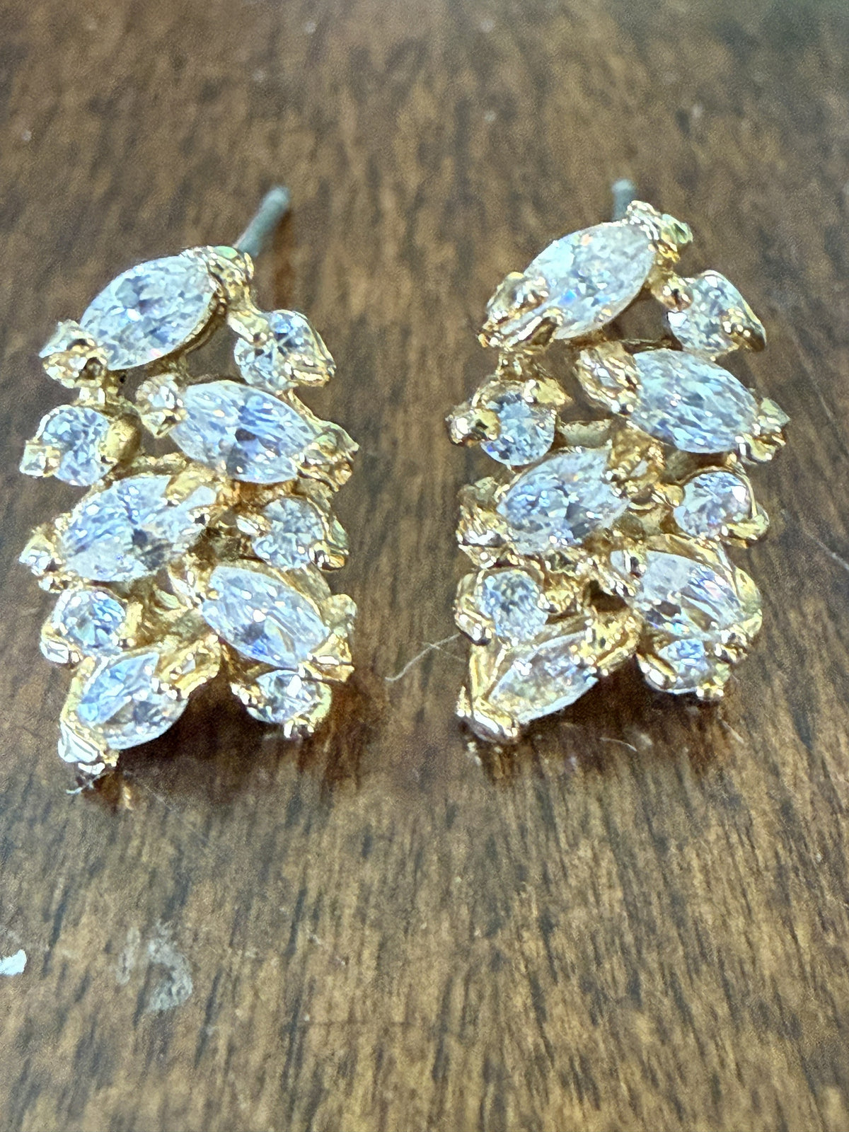 Front view of gold-tone marquise crystal cluster pierced earrings with cascading wheat spray rhinestone design