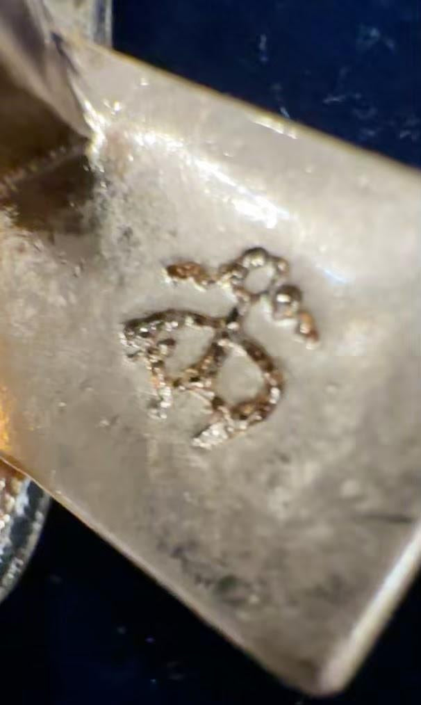 Close-up of Brooks Brothers BB monogram signature on brooch