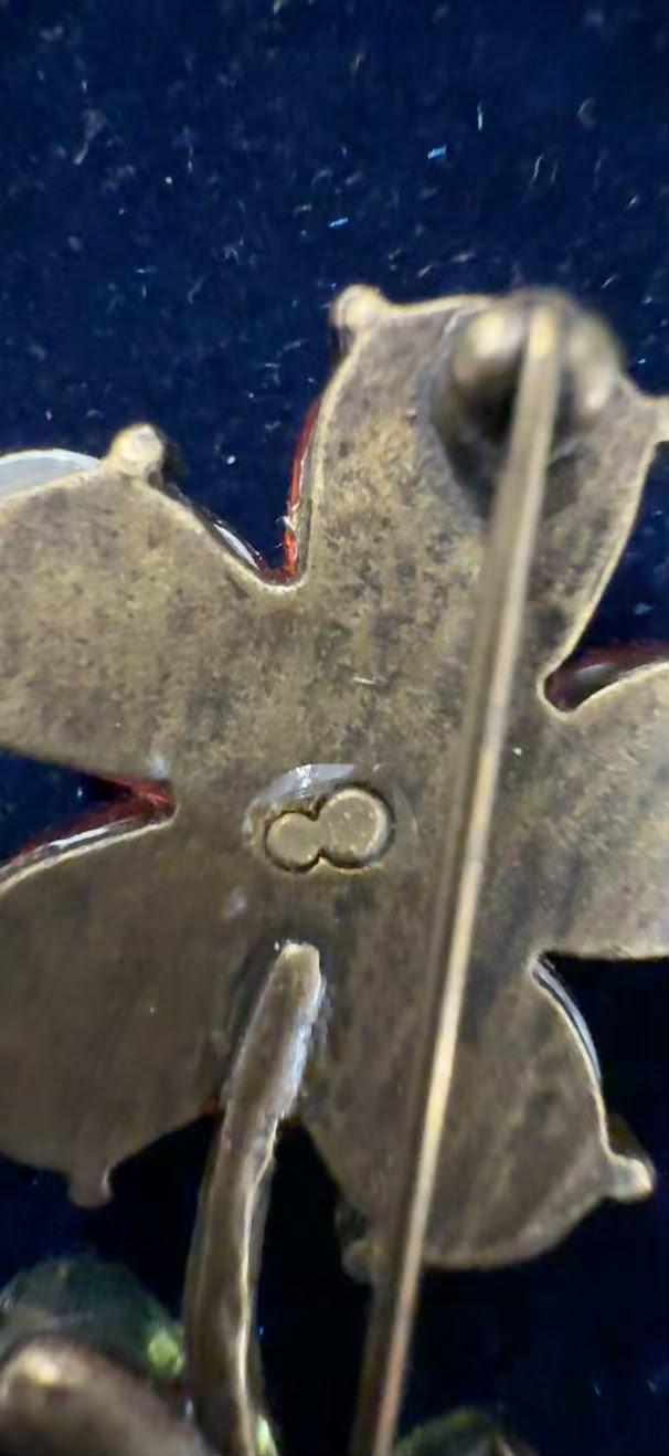 Vintage flower brooch back showing maker's mark stamp